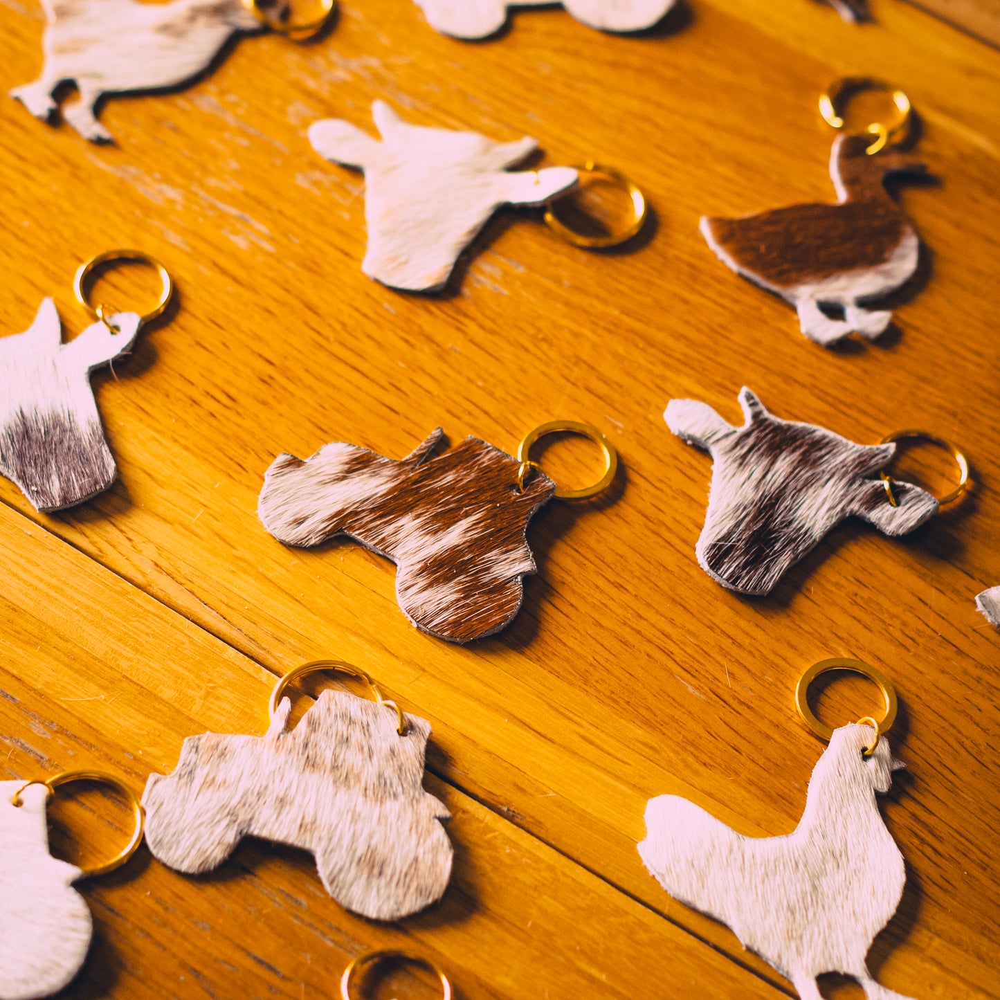 Set of animal-shaped keyrings with gold rings, dappled brown and white