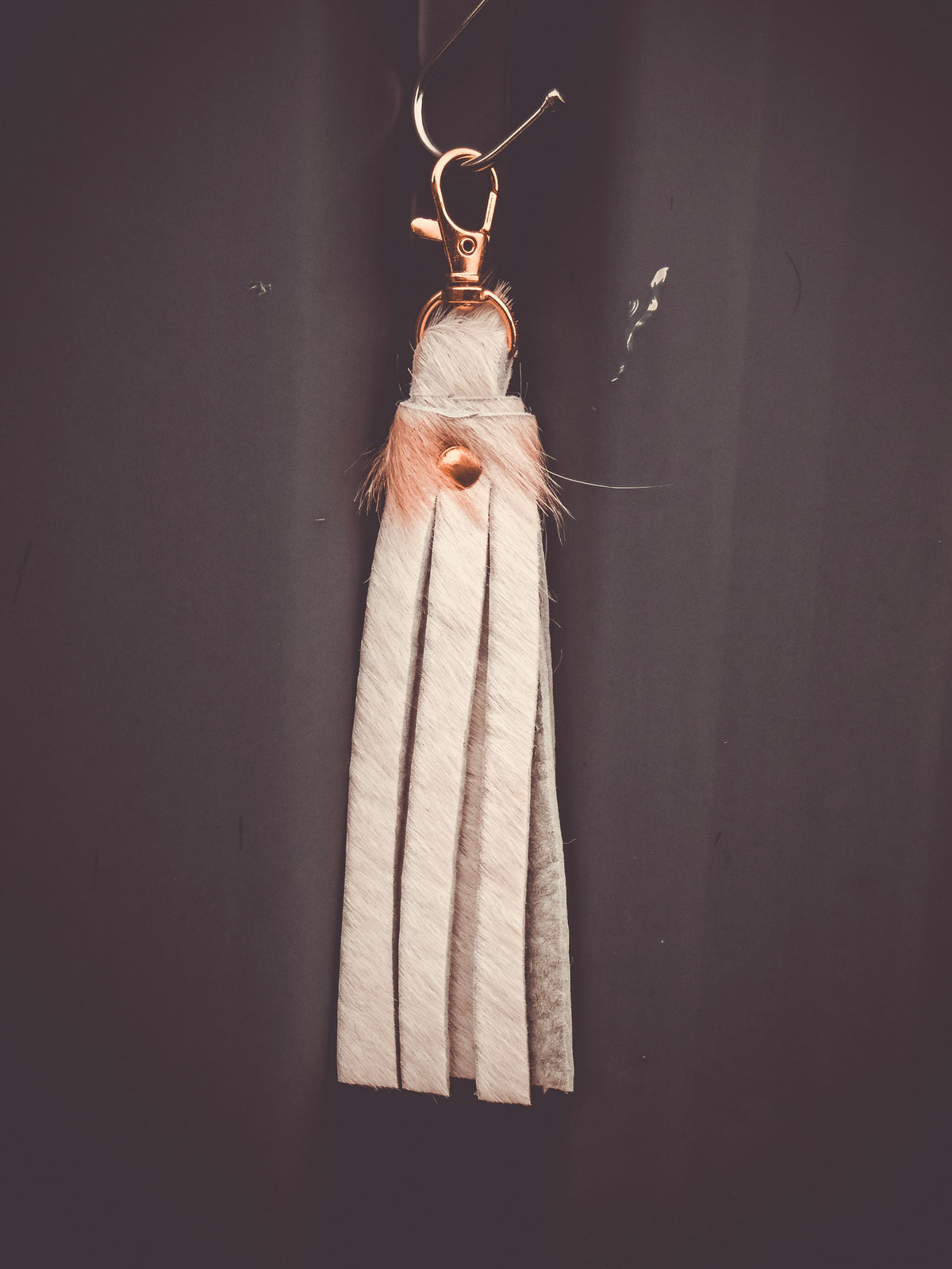 Fringed cowhide keyring bag charm with striped leather tassel and metal clasp