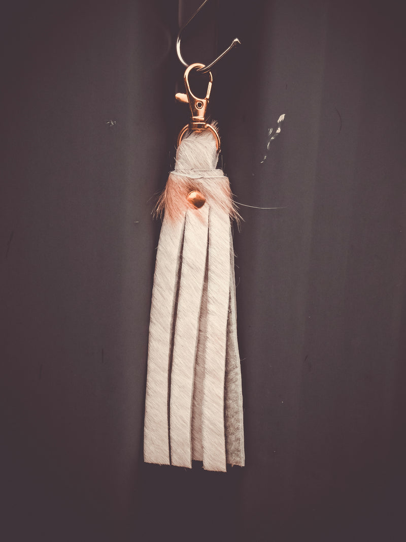 Fringed cowhide keyring bag charm with striped leather tassel and metal clasp