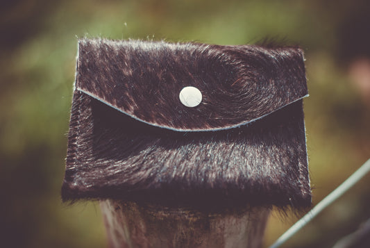 Small cowhide purse with front flap and round snap button
