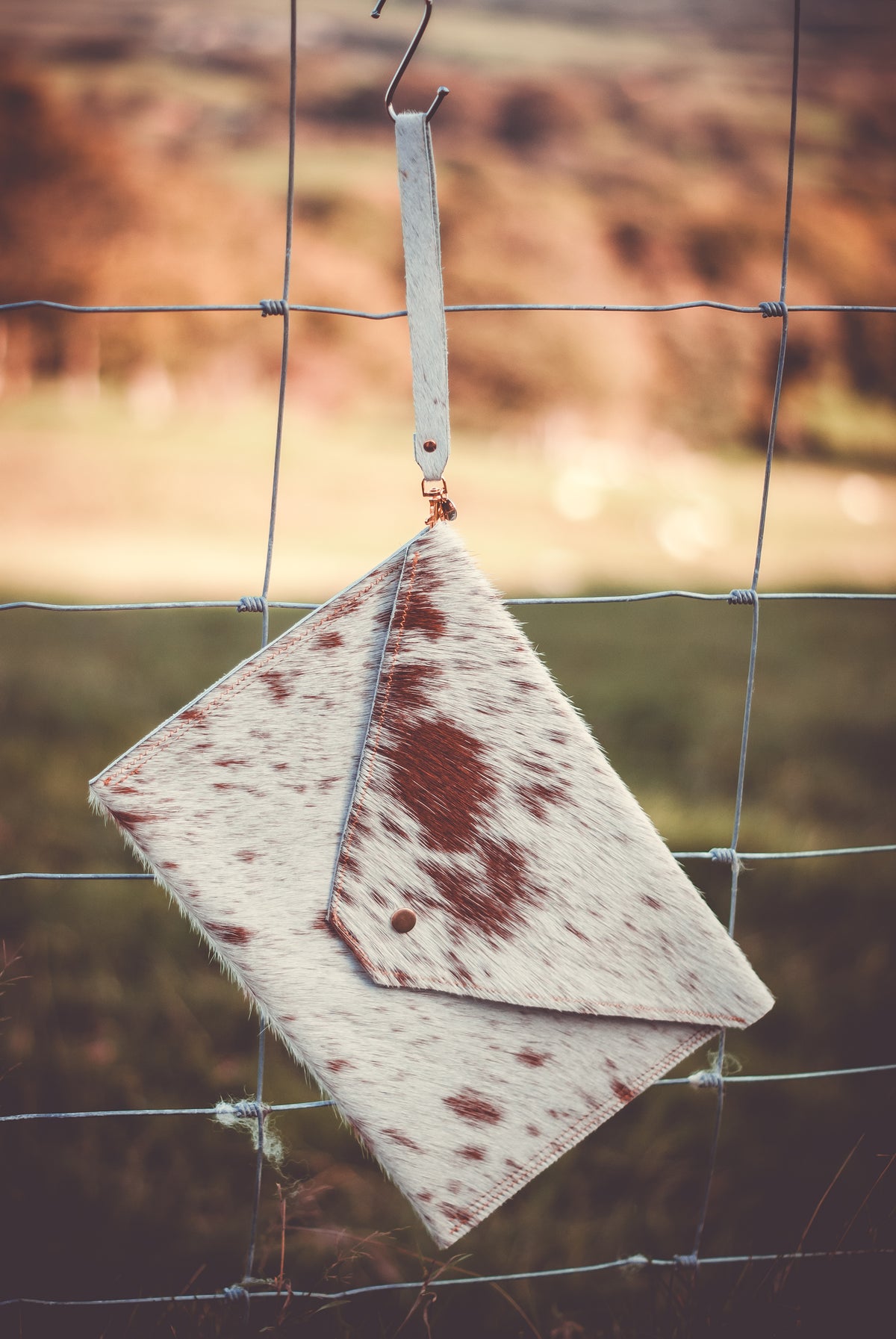 Cowhide envelope clutch bag, white with brown spots and leather flap