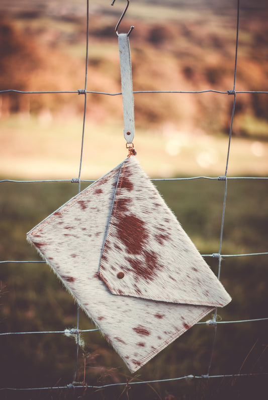 Cowhide envelope clutch bag, white with brown spots and leather flap