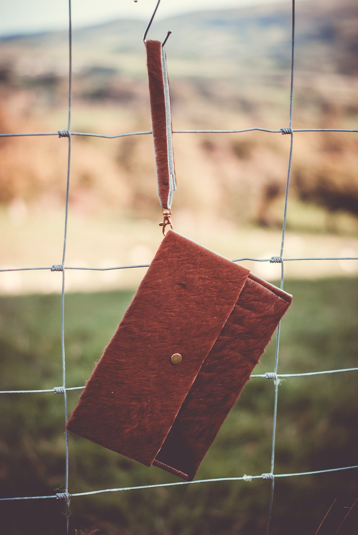 Cowhide clutch bag, compact burgundy-brown with flap and brass button